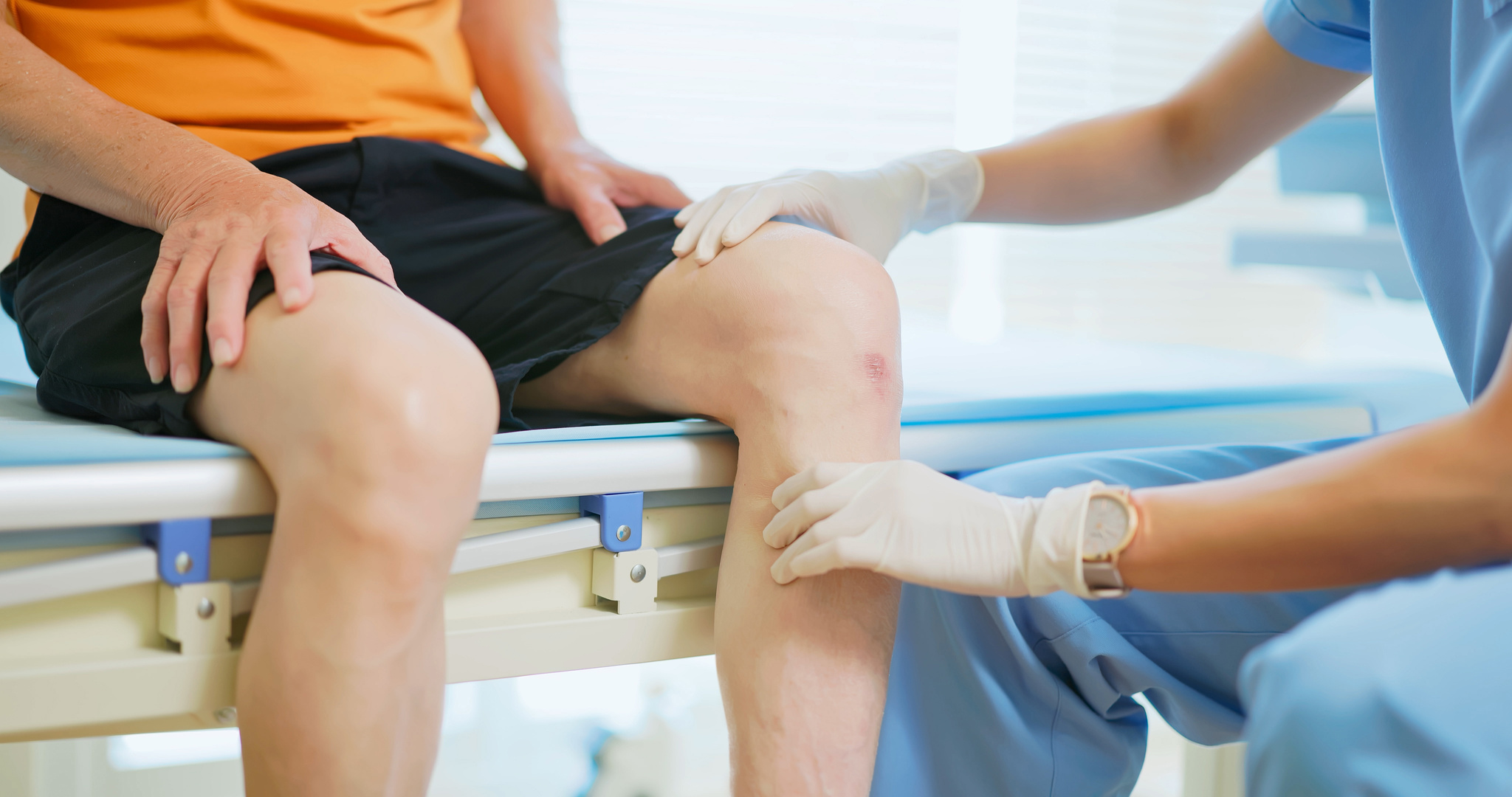 doctor examining patient knee